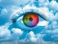 a rainbow coloured eye looking out of the clouds suggesting mystery, clairvoyance, intuitive sight, healing and guidance